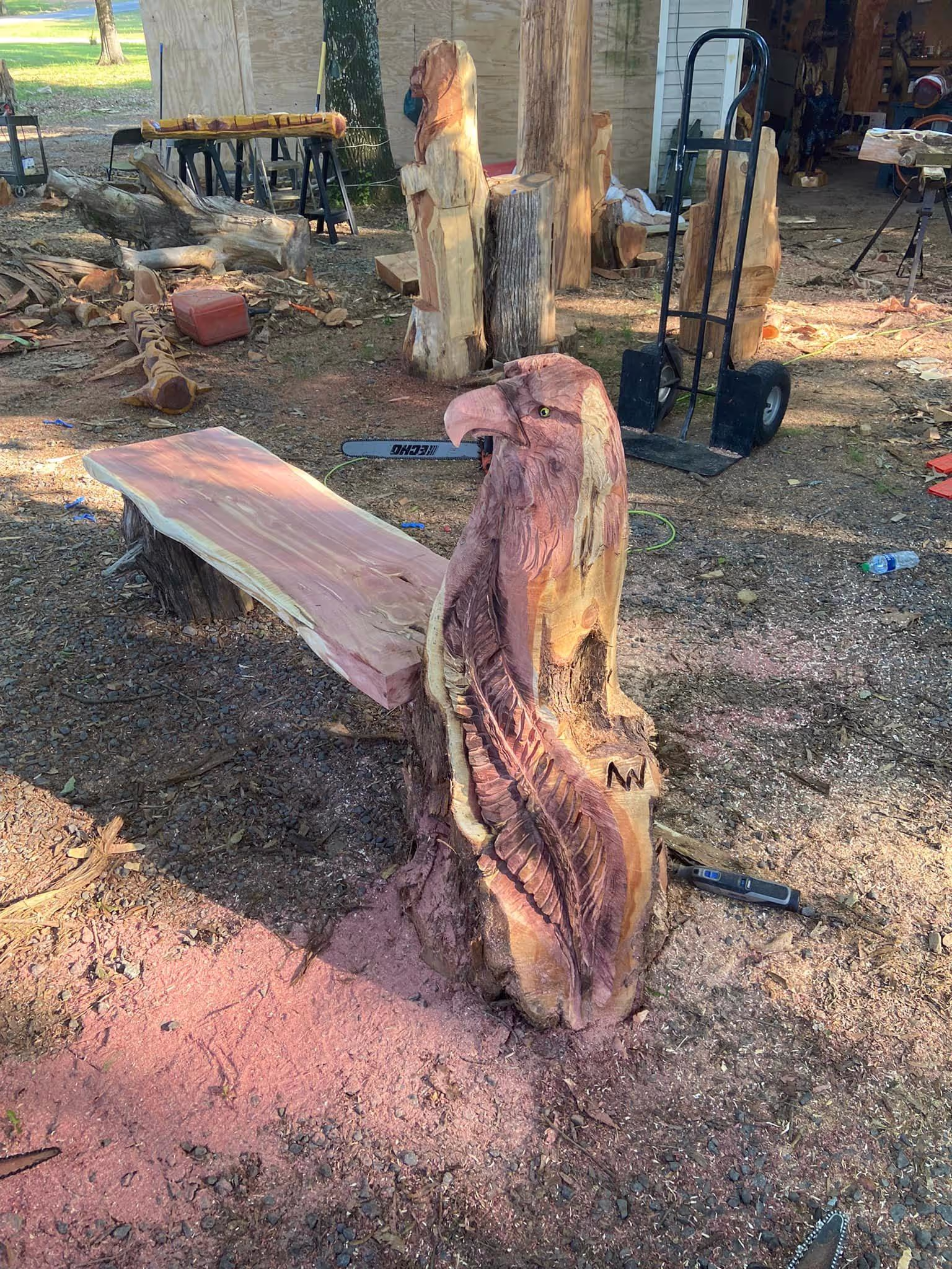 Carved eagle bench, birds of prey chainsaw art